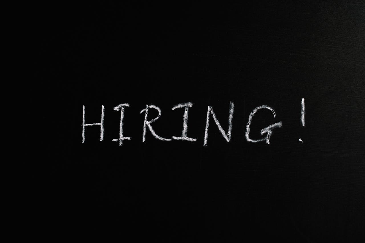 our-story Close-up of the word Hiring! written in white chalk on a blackboard, ideal for recruitment themes.